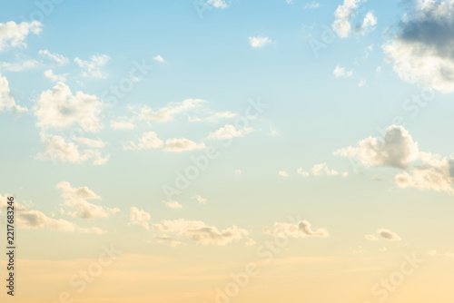 Sunset sky, light pale sunset sky with sun, clouds and sunset colorful sky