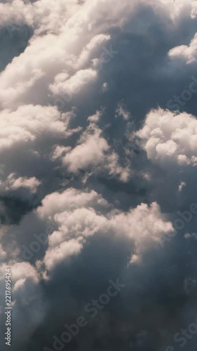 thunderstorms in Cumulus Clouds Rising Through a Dark Blue Sky
