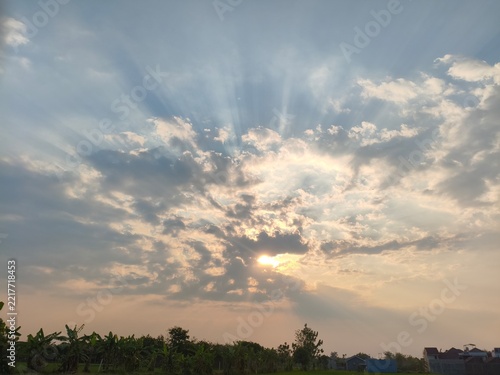 Stunning Crepuscular Rays Piercing Through Dramatic Clouds During Golden Hour