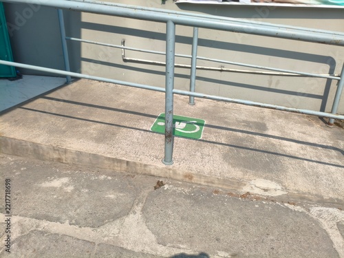 Accessible Handicap Ramp with Universal Wheelchair Symbol on Concrete Surface
