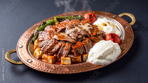 Traditional turkish iskender kebab with sliced meat tomato sauce
