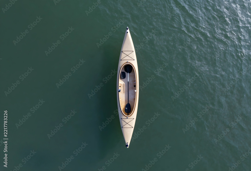 Fototapeta premium Adventure travel and outdoor recreation, empty kayak floating on calm water surface viewed from above for summer vacation and active lifestyle