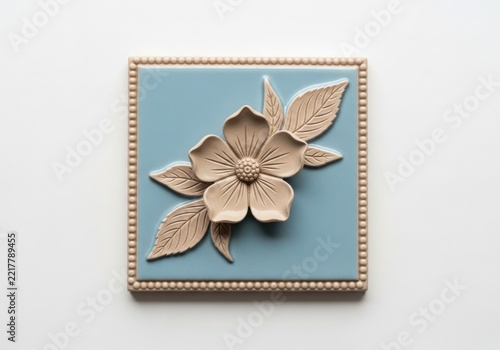 Beautiful metallic flower with green leaves on decorative background