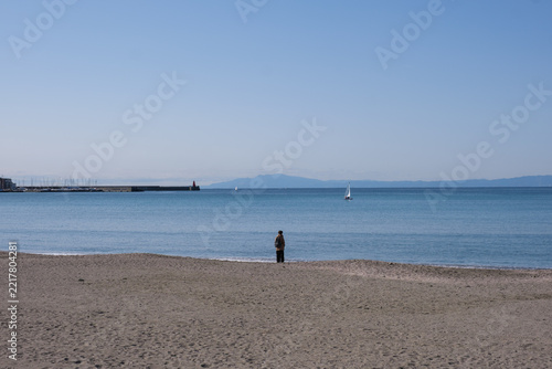 Lonely Figure Standing on Zushi Beach Overlooking Calm Blue Ocean Waters, Quiet Seaside Landscape and Authentic Local Life Near Kamakura and Tokyo