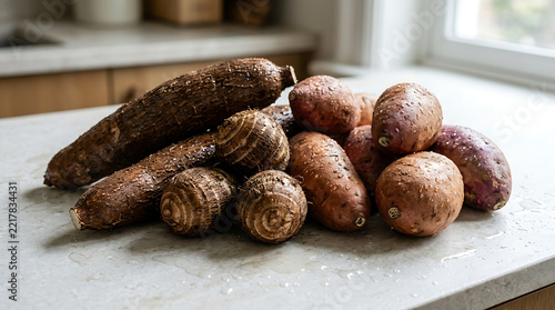 Assortment of Fresh Raw Cassava and Sweet Potato Roots on Kitchen Countertop