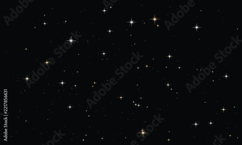Golden and white eight-point sparkling stars glowing on a dark black night sky