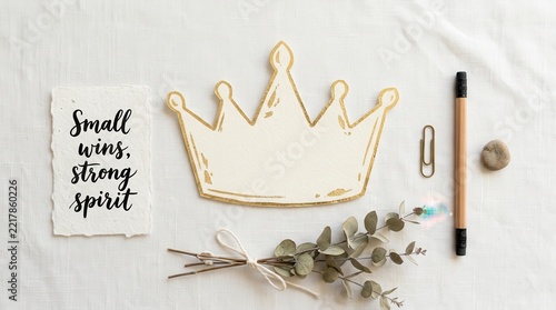 White crown decoration with gold trim on a table