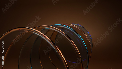 Abstract composition of overlapping curved glass rings with warm brown and blue light reflections