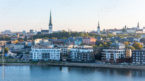 Panoramic aerial view of Tallinn with St. Olaf's Church, Old Town towers and modern Kalaranna waterfront, Estonia