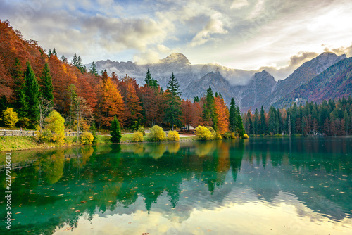 Magic of autumn. Among the woods and reflections on the Fusine lakes. Tarvisio