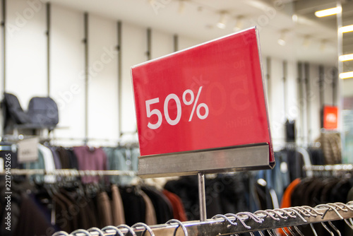 50% off red sale sign in a clothes shop, discounts, season sale, autumn-winter season