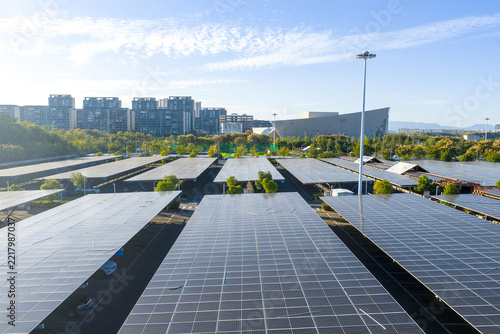 Obraz na plátně Neatly arranged solar photovoltaic panels on urban rooftops generating clean ene