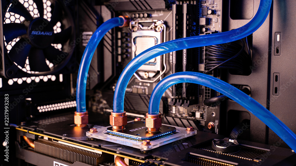 Fototapeta premium Liquid cooling loop over a processor - clear tubing carrying blue