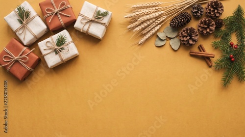 Flat lay composition with gift boxes and autumn or winter spices on yellow
