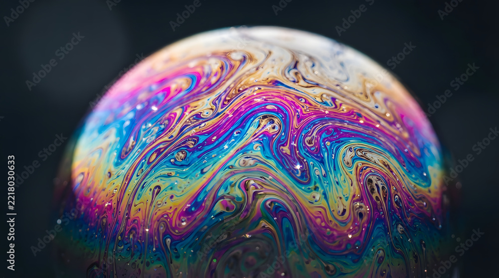 Fototapeta premium Macro photography of a soap bubble with iridescent rainbow colors and swirling patterns