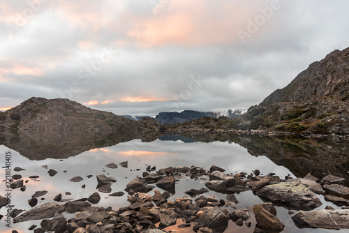 Serene Alpine Lake at Dawn with Mountain Reflections