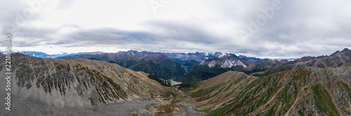 Panoramic view of snow-capped mountains and alpine valley in Sichuan