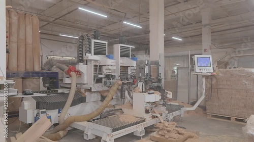 Automated routing process creates an interlocking joint for furniture manufacturing and wood assembly. CNC woodworking machine milling a precision edge profile on a wooden board.