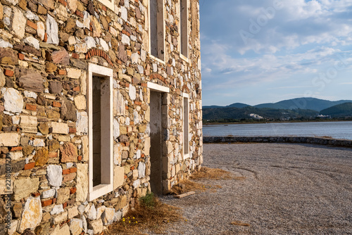 Rustic Stone Building Wall by Waterfront with Mountain View