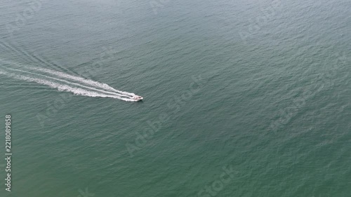 Aerial. Sandy coasts beaches filmed from the sky drone. fast boat speeding across the ocean