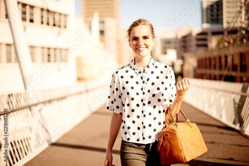 Canvas Print Walking, handbag and portrait of woman in town for sightseeing on vacation, getaway or weekend trip
