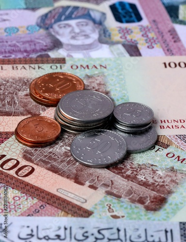 Omani rial money notes and coins on table. Oman cash bills of OMR currency close up