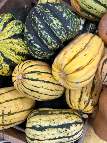 wooden crate filled with assorted winter squash at the market
