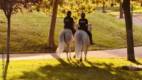 Spanish mounted police officers patrolling a park in madrid