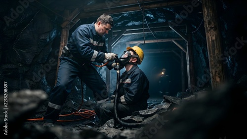 Rescue operation in underground mine with worker assisting injured colleague