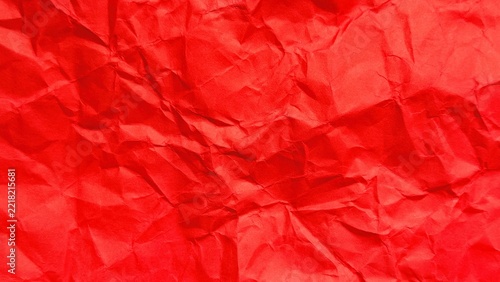 Vibrant red crumpled paper background showing heavy creases and an organic fibrous texture pattern
