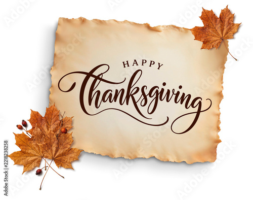Happy Thanksgiving calligraphy on torn vintage parchment with dried maple leaves and berries, isolated with no background