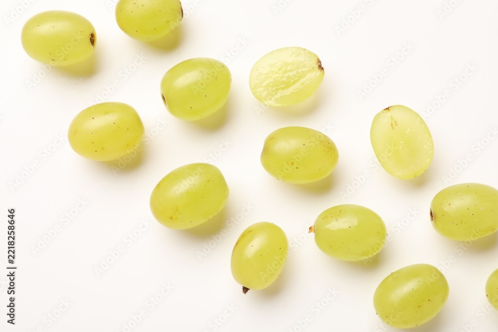 Fototapeta premium Fresh ripe grapes on white background, flat lay