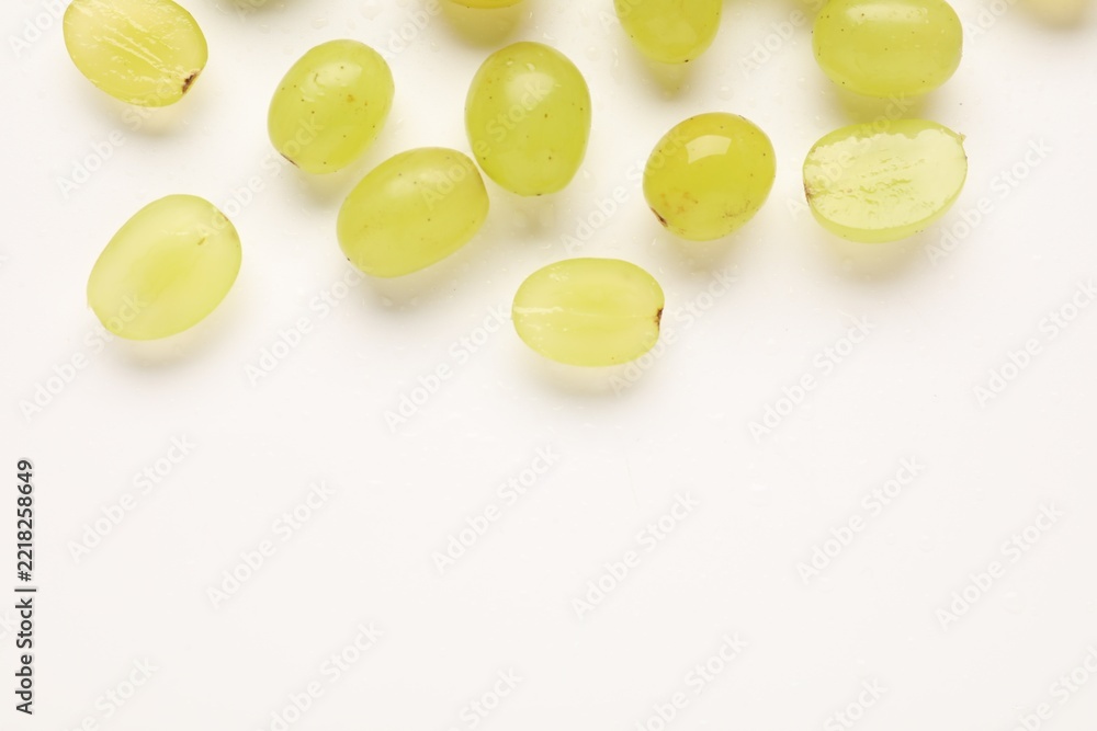 Fototapeta premium Fresh ripe grapes on white background, flat lay. Space for text