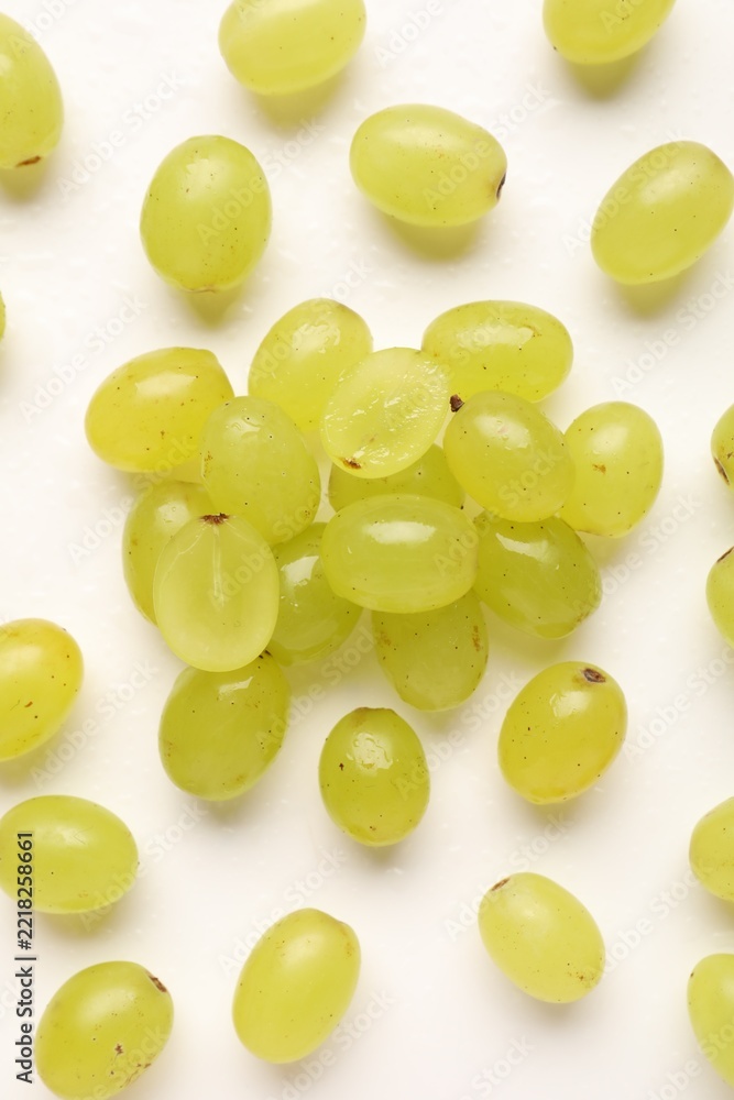 Fototapeta premium Fresh ripe grapes on white background, flat lay