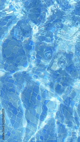 Blue Swimming Pool Water with Sunlight Reflections and Ripples