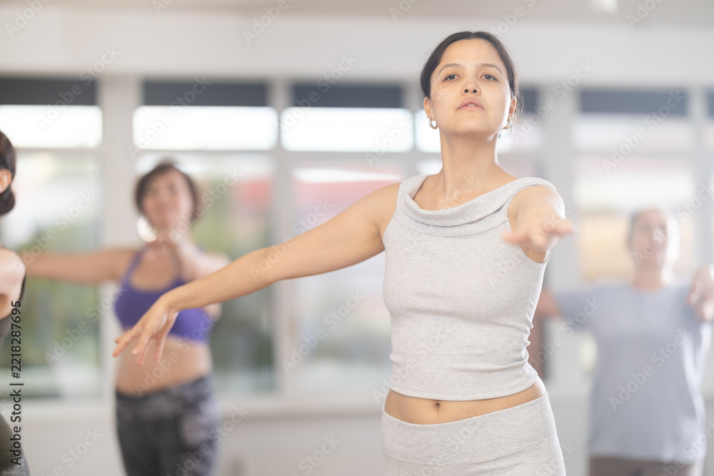 Naklejka premium Graceful women of different ages practice various ballet movements in a choreographic studio