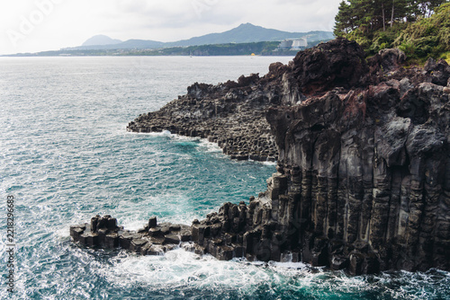 Daepo Jusangjeolli Cliff with columnar basalt jointing and waves, Daepo-dong, Jungmun, Ieodo-ro, Seogwipo, Jeju island, Jeju-do, South Korea, volcanic rock formation, Korean Natural Monument