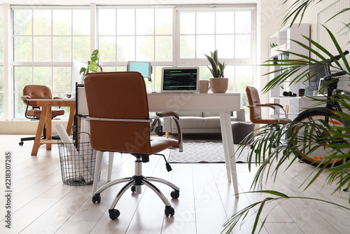 Remote work and digital nomad lifestyle, modern home office with laptop showi...