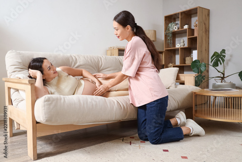 Prenatal care and pregnancy support, woman touching baby bump of expectant mo...
