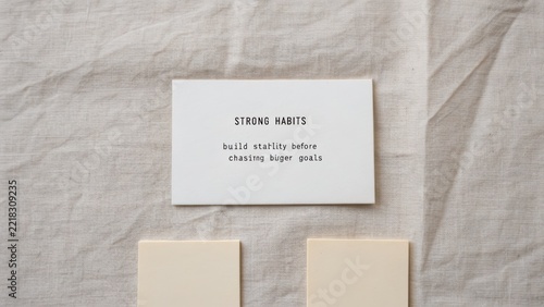 Strong habits card on fabric surface promoting personal development