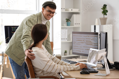 Software development collaboration, diverse team of programmers working on co...