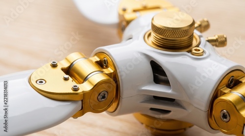 High-Precision Drone Rotor Assembly with White Blades and Polished Gold Details.