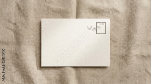 Blank postcard template on natural linen fabric background top view.