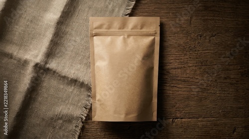 Kraft paper stand up pouch mockup on dark wood.