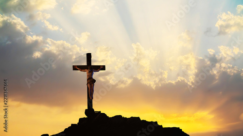 Obraz na plátně Jesus Christ Crucified on Cross at Golgotha Against Dramatic Sunset Sky 3D Rende