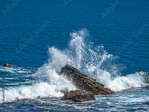 Ocean waves crashing against jagged rocks in Xuhai, Pingtung, Taiwan. 