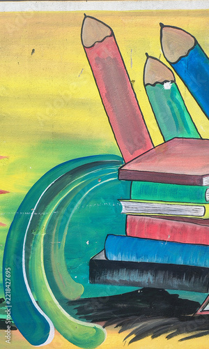 Colorful illustrated crayons and notebook on a desk