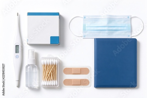 First Aid Essentials Flat Lay with Thermometer Cotton Swabs Bandages Mask and Pouch