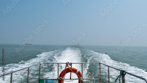 Speedboat sailing on sea with wake waves