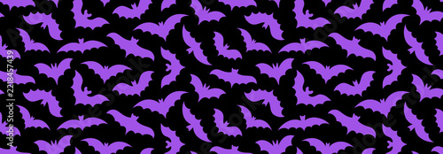 Purple Halloween bat seamless pattern. Spooky flying bats silhouette background. Repeating print design for wrapping paper, fabric, textile, holiday decoration. Helloween repeated wallpaper. Vector
